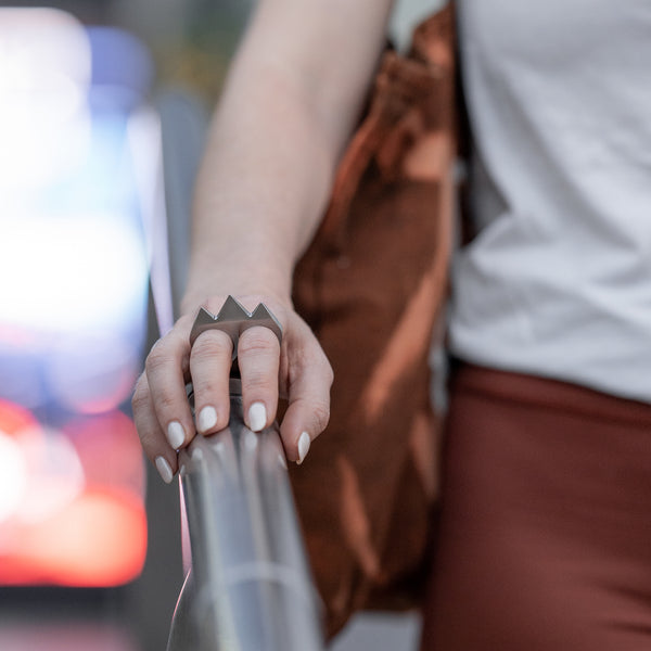 Woman Wearing Talon Knuckles Defense Ring in Subway