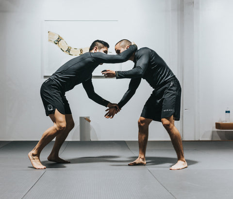 Two men grappling practicing BJJ