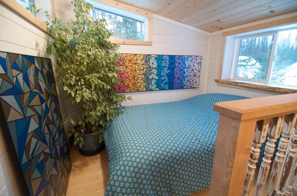 This 38' gooseneck tiny house on wheels is built by Nelson Tiny Houses based in Nelson, British Columbia, Canada!  This huge tiny house features 380-sqft of floor space (including the gooseneck bedroom) and includes a very open floor plan. Inside, you'll find a multi-functional living/dining/work space upon entering the home, a huge kitchen with countertops and cabinets on opposite sides of the house, a mid-size bathroom with a toilet and shower, a bedroom on the gooseneck, and an additional loft above the living room that adds extra sleeping or storage space!  Follow Nelson Tiny Houses on Instagram or contact them here for any questions!  The “Winter Wonderland”—A 38’ Gooseneck Tiny House built by Nelson Tiny Houses  The “Winter Wonderland”—A 38’ Gooseneck Tiny House built by Nelson Tiny Houses  The “Winter Wonderland”—A 38’ Gooseneck Tiny House built by Nelson Tiny Houses