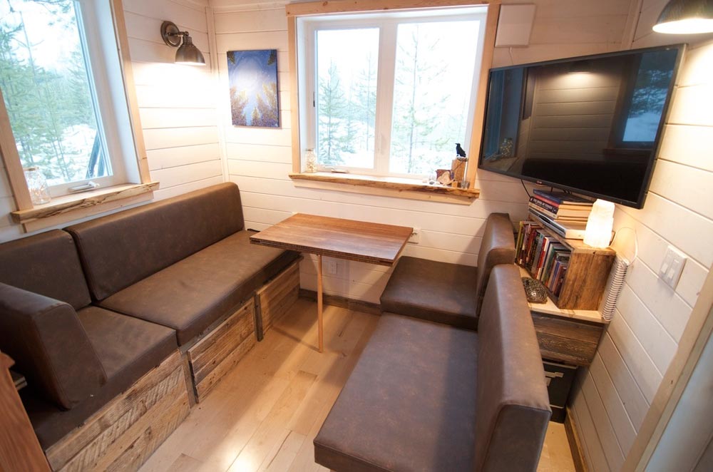 This 38' gooseneck tiny house on wheels is built by Nelson Tiny Houses based in Nelson, British Columbia, Canada!  This huge tiny house features 380-sqft of floor space (including the gooseneck bedroom) and includes a very open floor plan. Inside, you'll find a multi-functional living/dining/work space upon entering the home, a huge kitchen with countertops and cabinets on opposite sides of the house, a mid-size bathroom with a toilet and shower, a bedroom on the gooseneck, and an additional loft above the living room that adds extra sleeping or storage space!  Follow Nelson Tiny Houses on Instagram or contact them here for any questions!  The “Winter Wonderland”—A 38’ Gooseneck Tiny House built by Nelson Tiny Houses  The “Winter Wonderland”—A 38’ Gooseneck Tiny House built by Nelson Tiny Houses  The “Winter Wonderland”—A 38’ Gooseneck Tiny House built by Nelson Tiny Houses