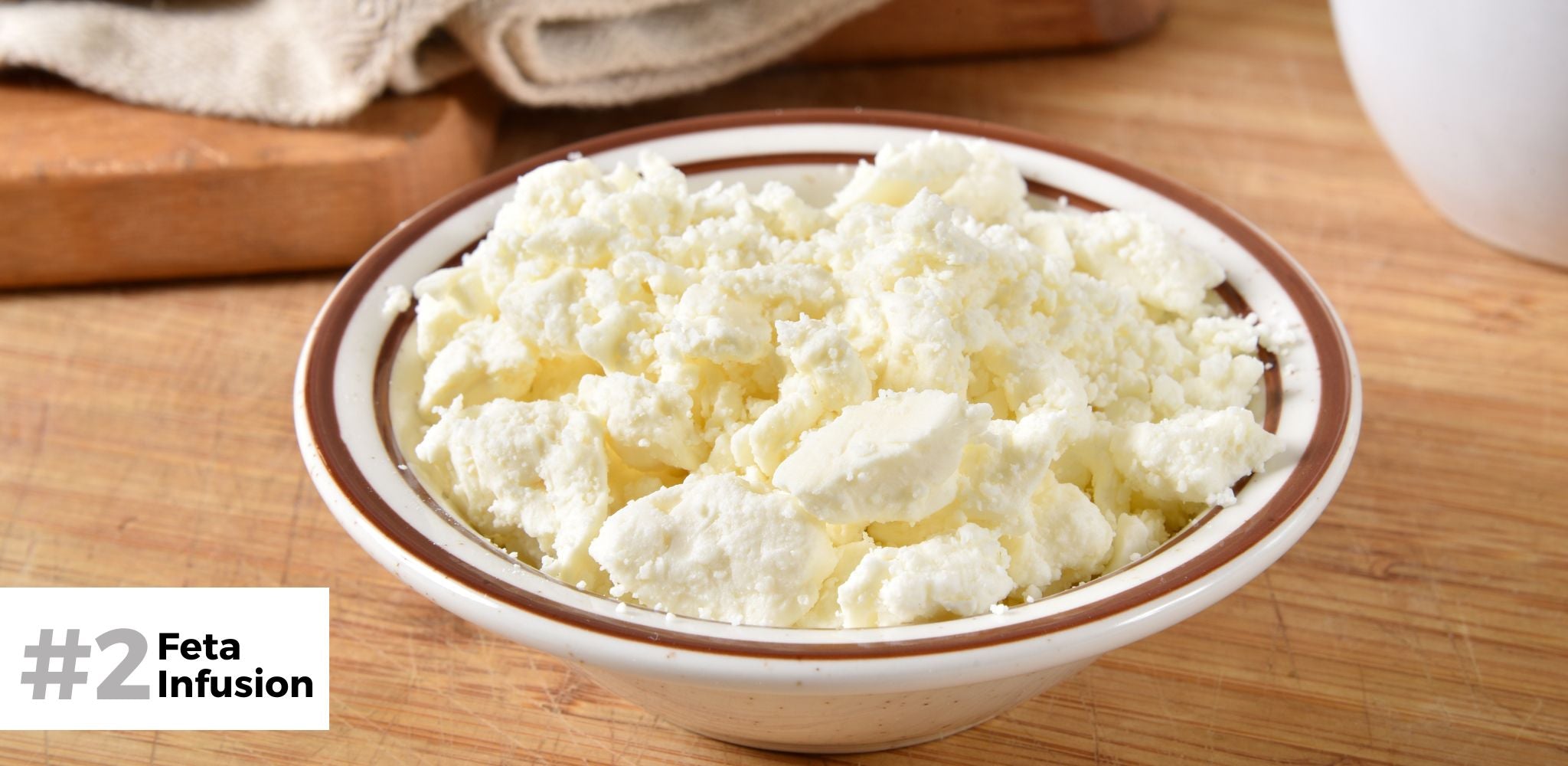 Crumbled Feta Cheese in a bowl with wooden background