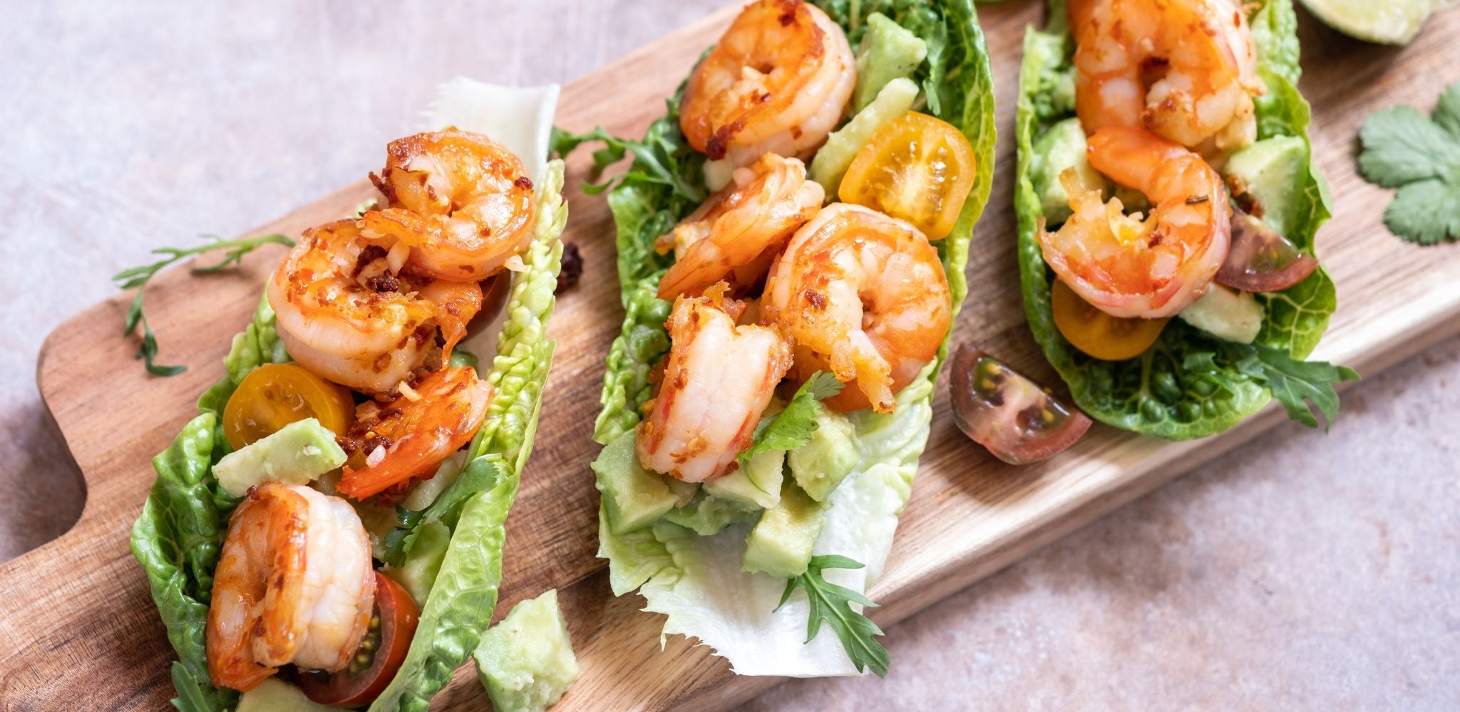 Shrimp on a lettuce taco shell, with delicious avocado and a drizzle of extra virgin olive oil