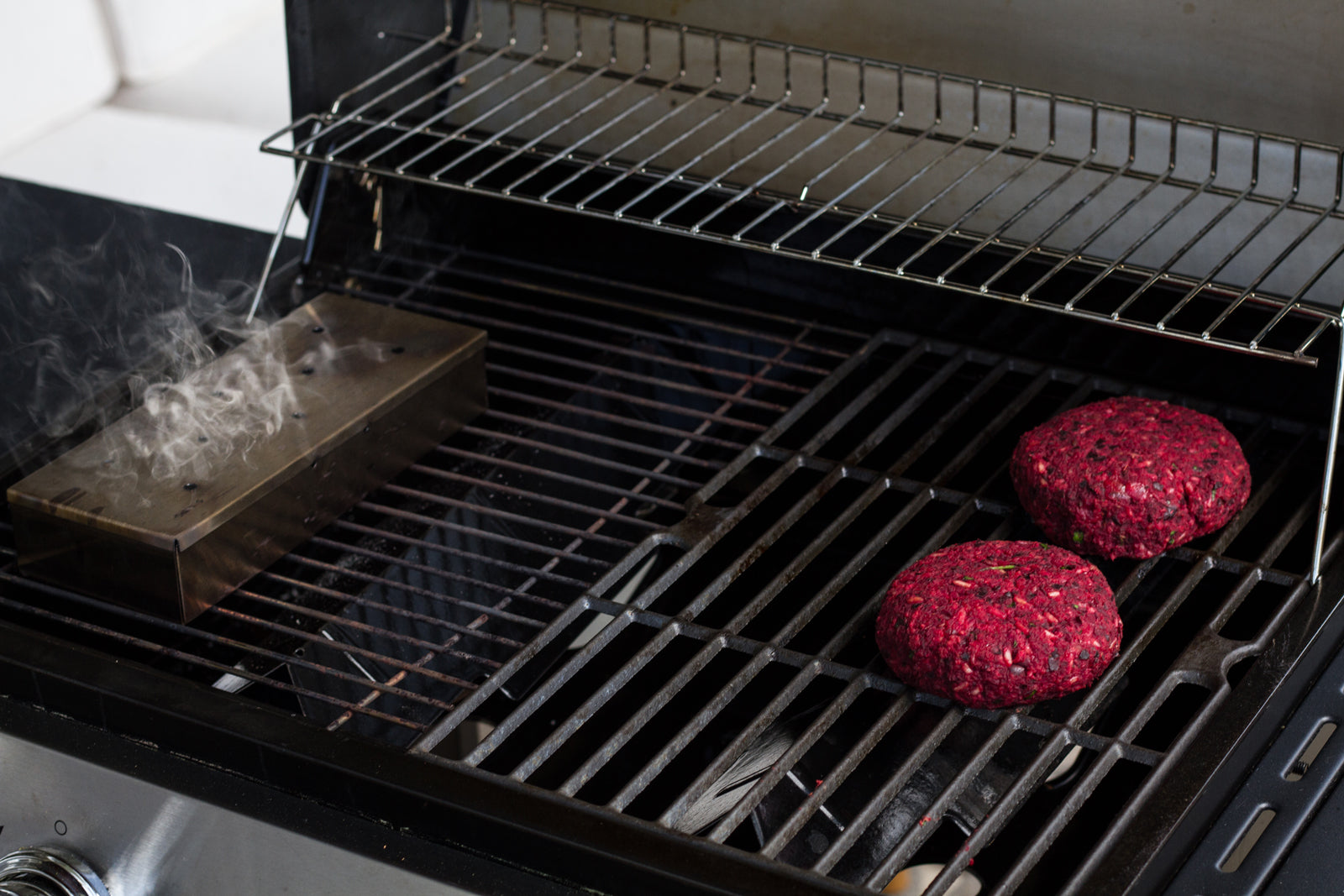 smoking beet burger on the grill with a smoker box