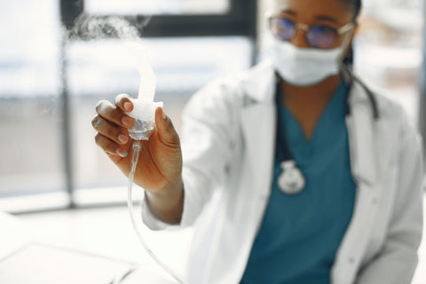 nurse holding nebuliser