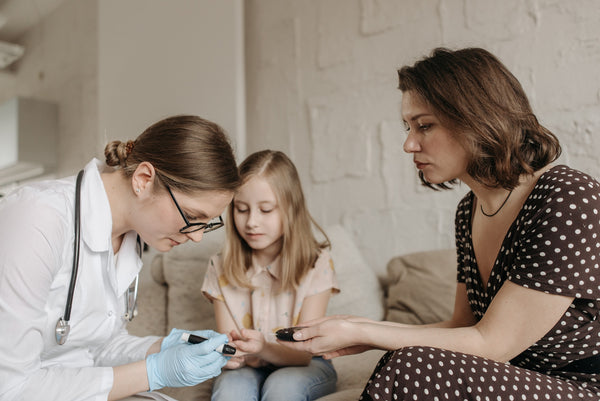 mother and diabetic daughter consulting doctor