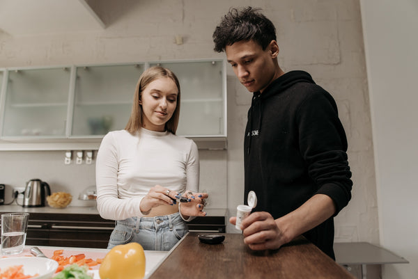 diabetic woman checking blood sugar level with partner