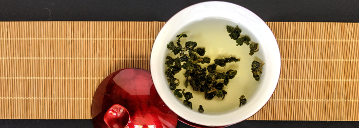 natural oolong tea leaves in a red gaiwan; studies show tea can help reduce stress