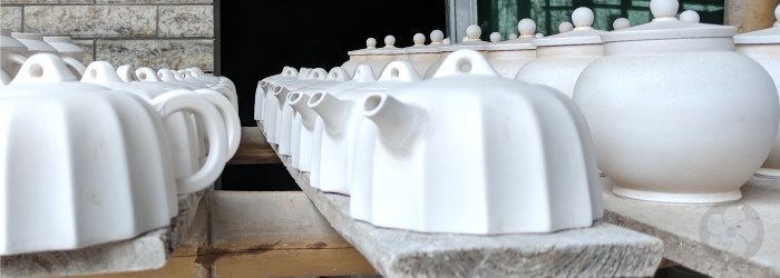 these pure white pots are made of porcelain, which is fired to very high temperatures