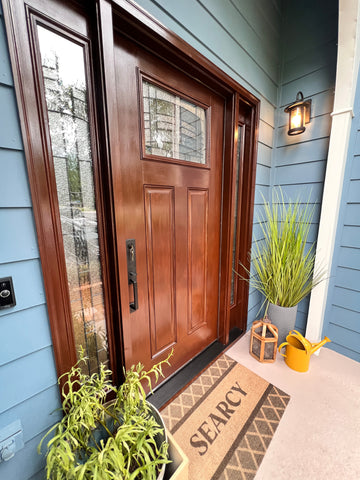 Matte Black Munich Handleset on a Wood Door on a Blue House