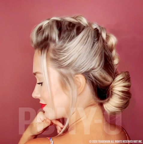 Dutch Braid on blonde hair with a Bow Bun at the base