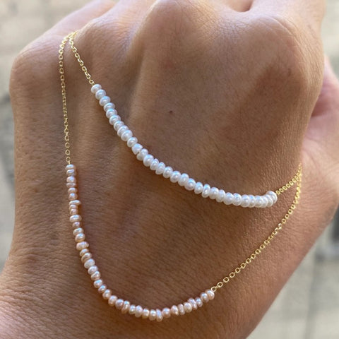 Arc Pearl Necklace displayed on hand