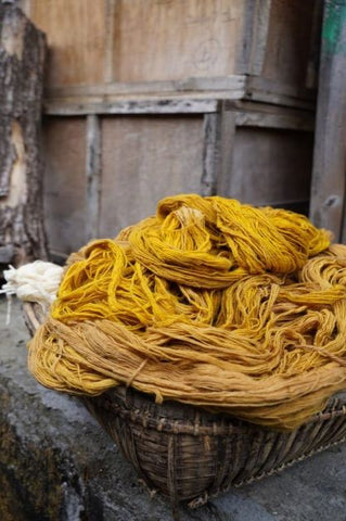 Basket full of natural dyed organic cotton to weave pillows for artha collections