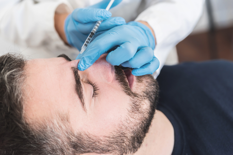 Botox Before and After Photo: Man receiving Botox procedure. Specifically Glabella Botox frown lines treatment