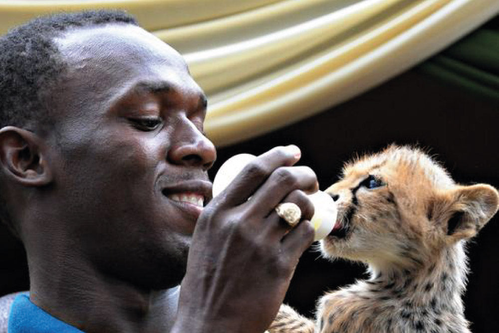 Usain Bolt y su mascota Cheetah