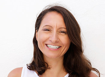 smiling woman in white tank top