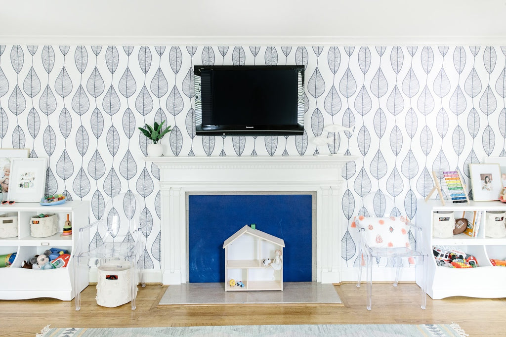 Blue leaves removable wallpaper in a white playroom interior