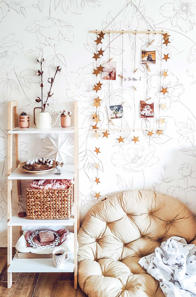 Boho style girls nursery with floral pink wallpaper and interior decor