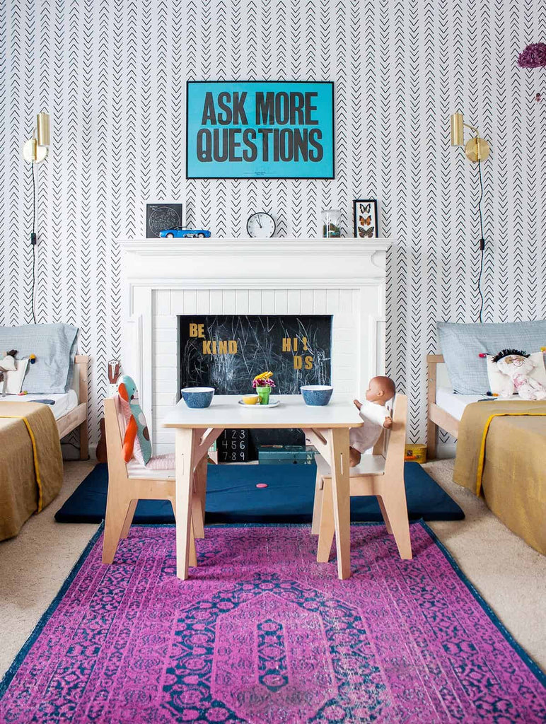 Bright shared kid's bedroom with Scandinavian wallpaper and coloful decor elements