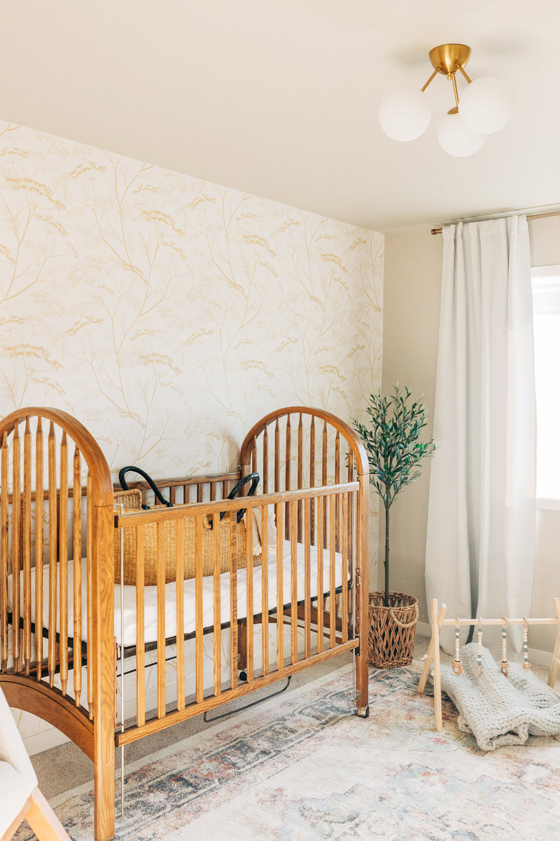 Modern farmhouse style nursery interior styled with botanical theme wallpaper