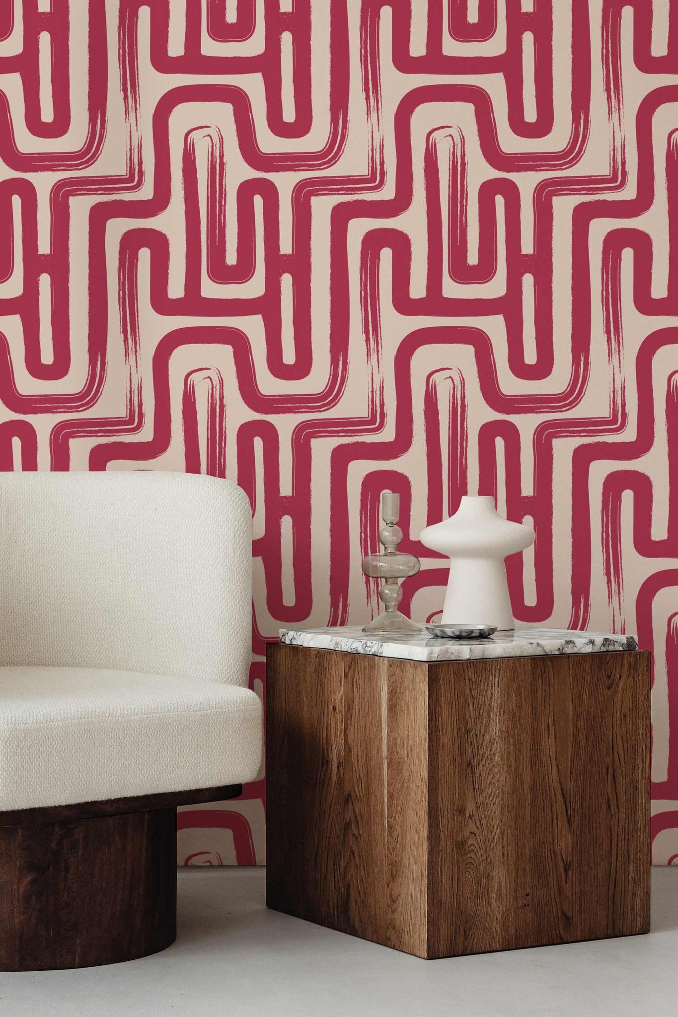 Bold magenta pink paintbrush maze wallpaper in neutral elegant livingroom inteiror with dark walnut wood and marble decor elements