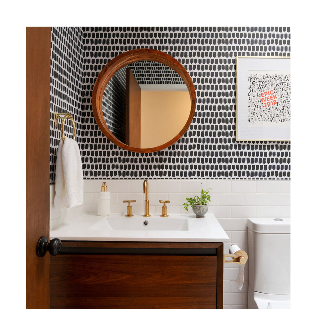 Mid-century modern powder room with bold removable wallpaper and brass decor