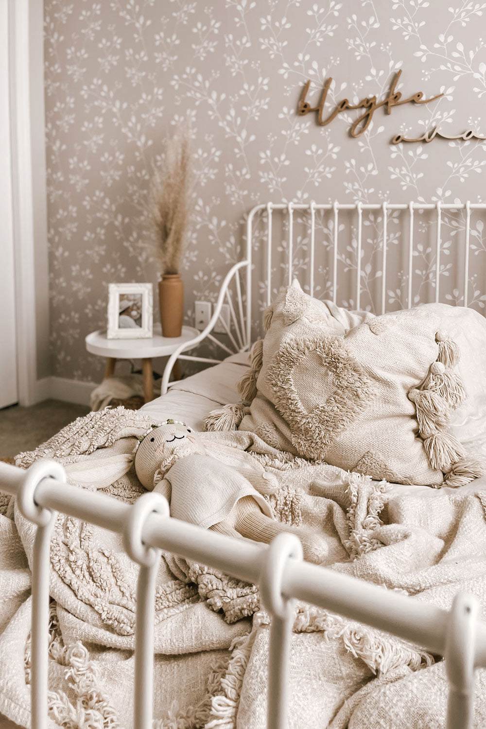 Neutral girl's bedroom design featuring wildflower foliage removable wallpaper