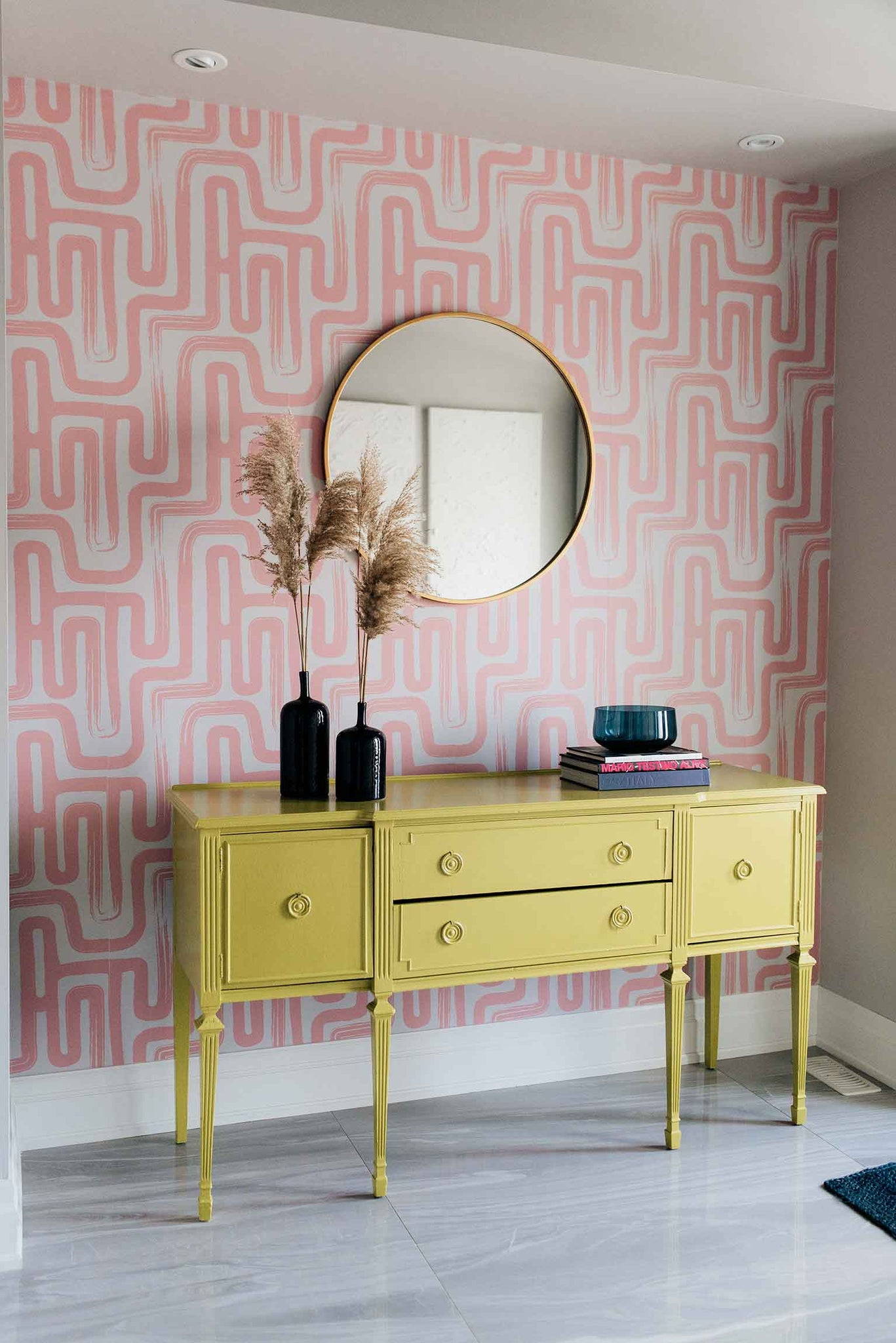 Pink eclectic entryway interior design with bold removable wallpaper