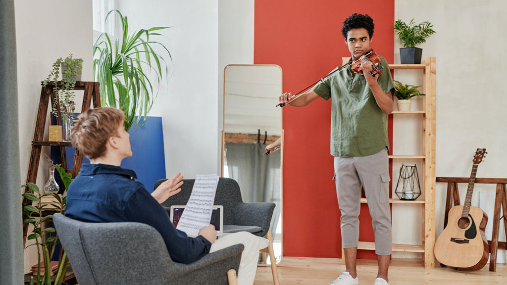 Playing violin in front of friend