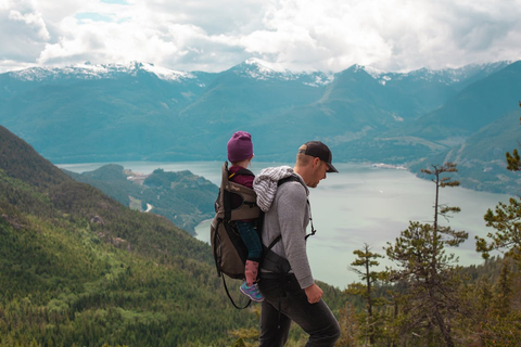 Man hiking with a baby strapped to his backpack