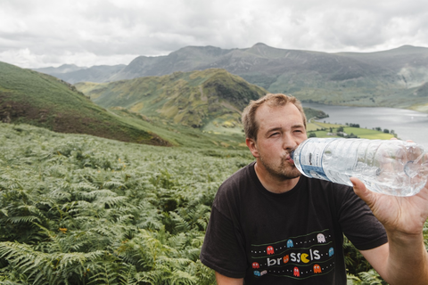 Hiker drinking water out of a bottle