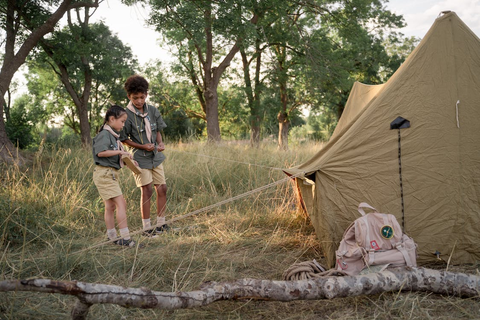 Two children setting up a camping tent