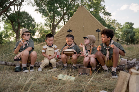 Children sitting outside a tent