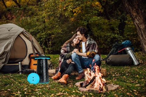A couple sitting in front of a campfire