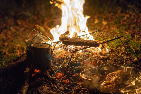 A camper grilling protein outdoors