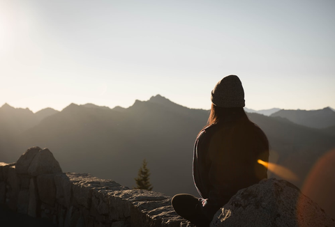 a hiker sitting on a wall