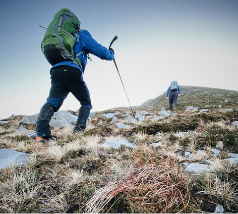 A hiker with an ultralight backpack and trekking poles