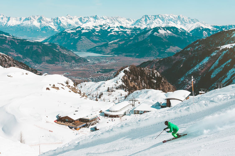 A ski professional descending a snowy mountain slope