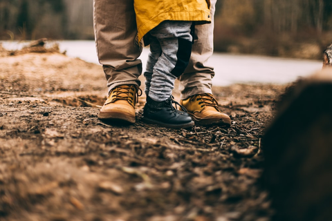 A kid with his father on a trail