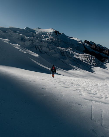 a man trekking in a snow-covered landscape