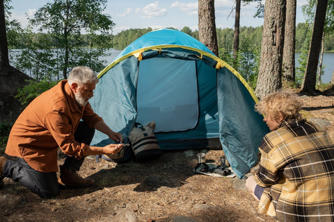 Two campers setting up a tent