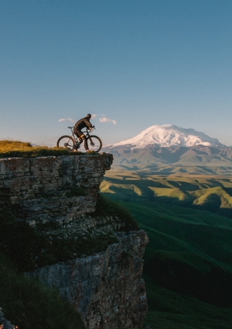 A person admiring the mountains while on a bicycle tour