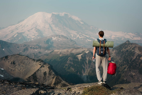 a person standing on the top of a mountain.