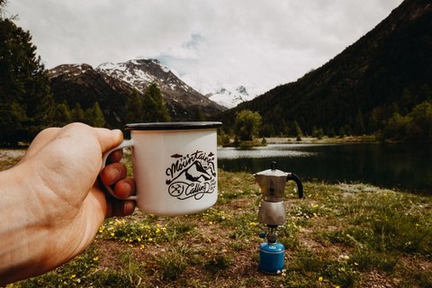 A camper holding his cup of coffee