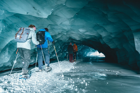 Ski experts exploring a snow cave