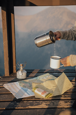 A hiker drinking water during a hiking trip.