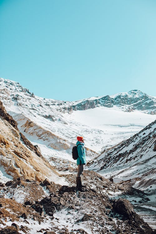 a woman standing between a mountain path