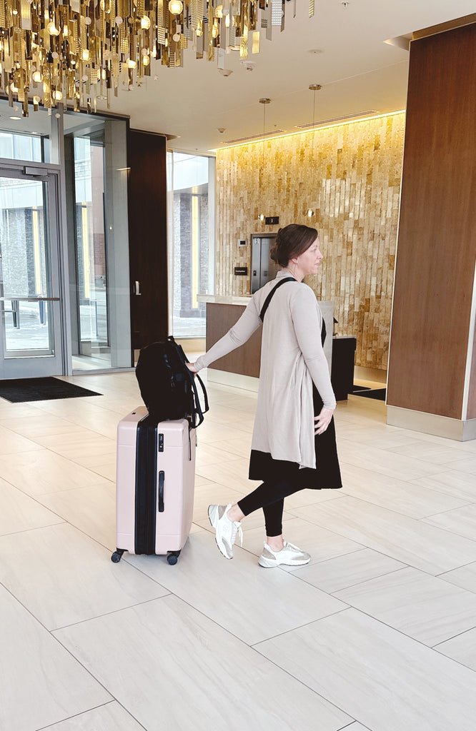 Women in Modest Clothing pulling luggage for travel