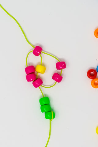 Wooden Beads On A String Making A Colorful Toy
