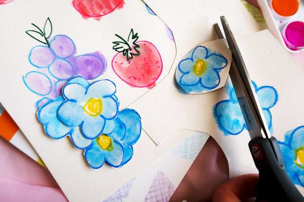 cutting out painted and drawn flowers with scissors