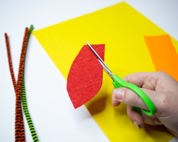 cutting out leaf shape from felt